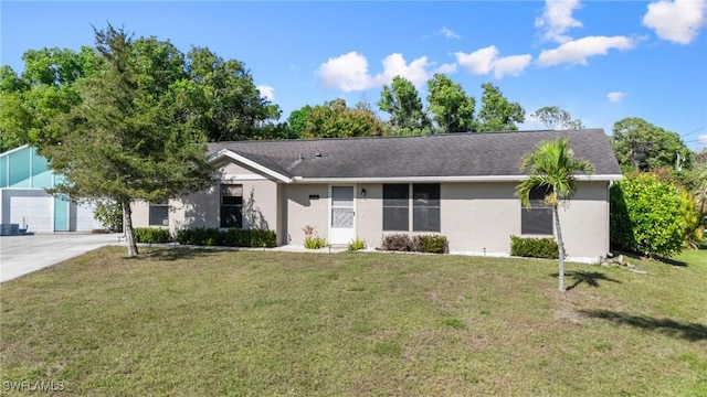 single story home with a garage and a front lawn