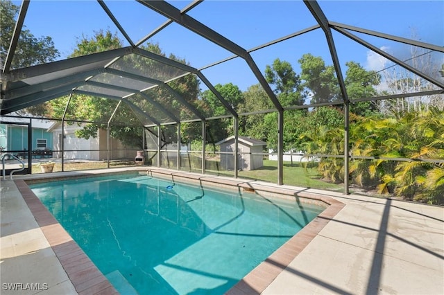 view of pool with a shed, a lanai, and a patio area