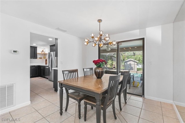 tiled dining area with an inviting chandelier