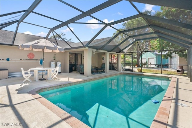 view of pool featuring glass enclosure and a patio area