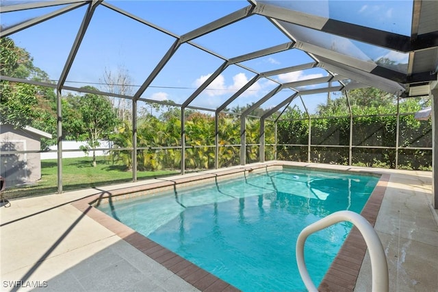 view of pool featuring a patio and glass enclosure