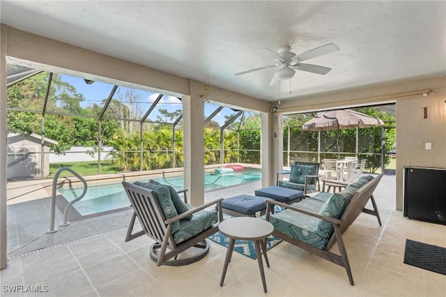 sunroom / solarium with ceiling fan and a swimming pool