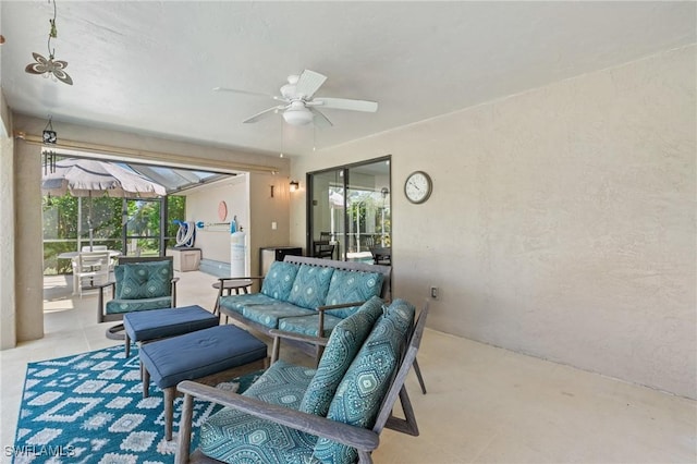 view of patio with an outdoor living space, a lanai, and ceiling fan