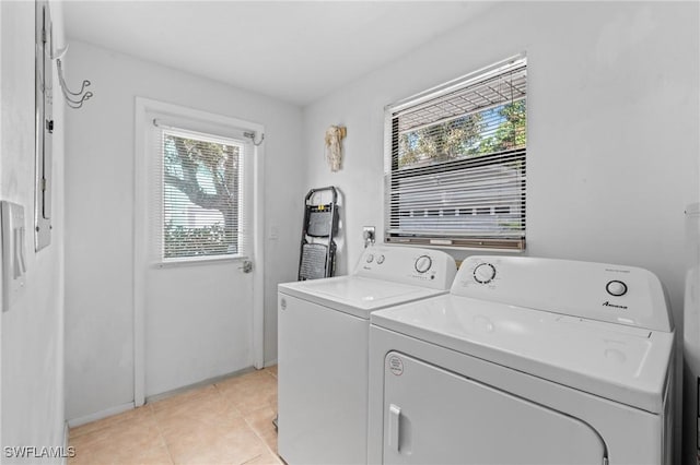 laundry room with separate washer and dryer and light tile patterned floors