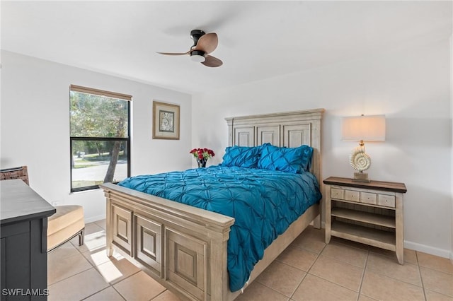 tiled bedroom featuring ceiling fan