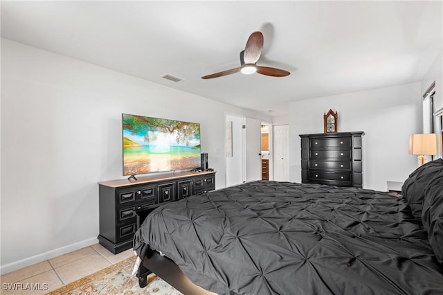 tiled bedroom featuring ceiling fan