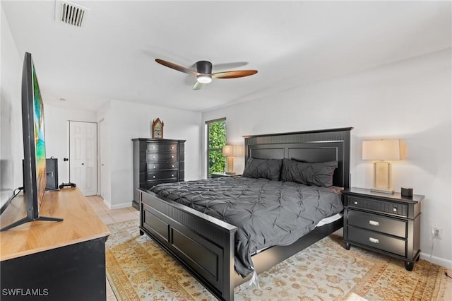 bedroom with light tile patterned floors and ceiling fan