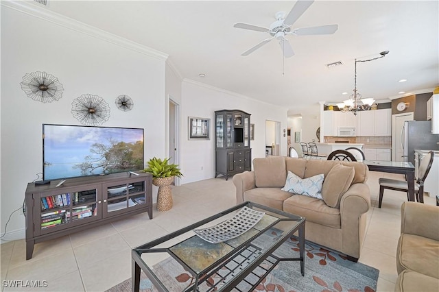 living room with light tile patterned flooring, crown molding, and ceiling fan with notable chandelier