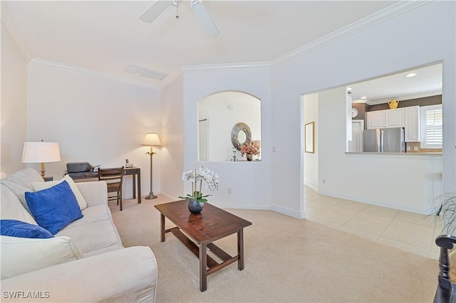 living room featuring light carpet, ornamental molding, and ceiling fan