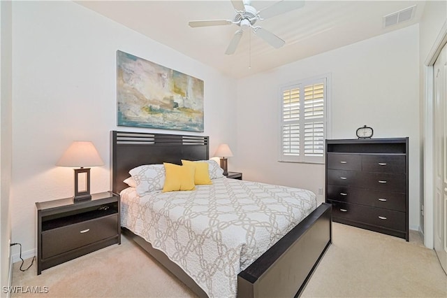 bedroom with ceiling fan and light colored carpet