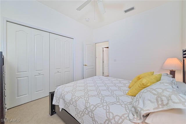 carpeted bedroom featuring a closet and ceiling fan