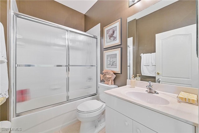 full bathroom featuring vanity, enclosed tub / shower combo, and toilet