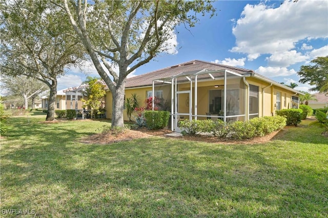 exterior space with a yard and glass enclosure