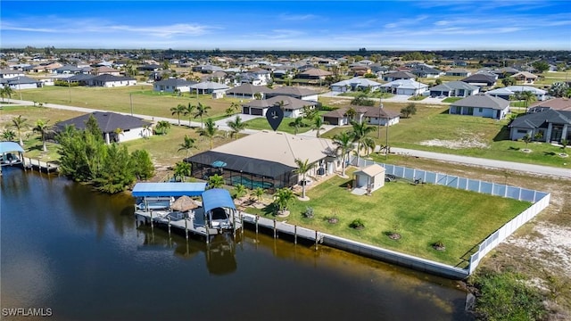 drone / aerial view featuring a water view and a residential view