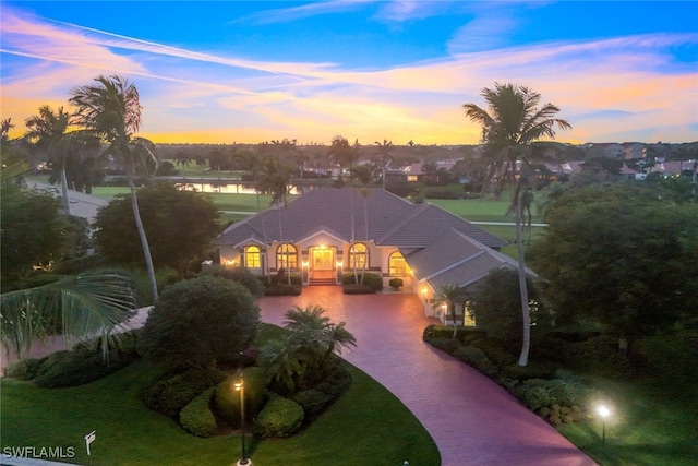 view of front of house featuring a yard and decorative driveway