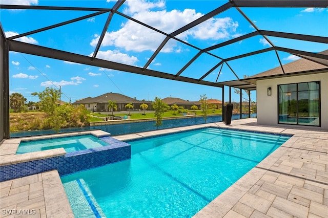 view of pool with an in ground hot tub, glass enclosure, and a patio area