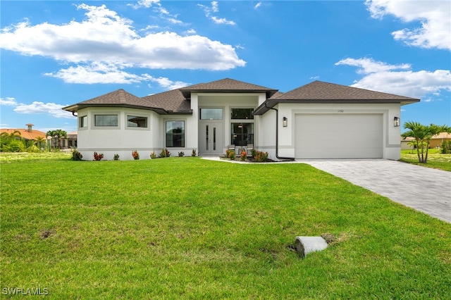 prairie-style home featuring a garage and a front yard