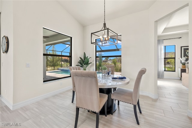 dining room with high vaulted ceiling and an inviting chandelier