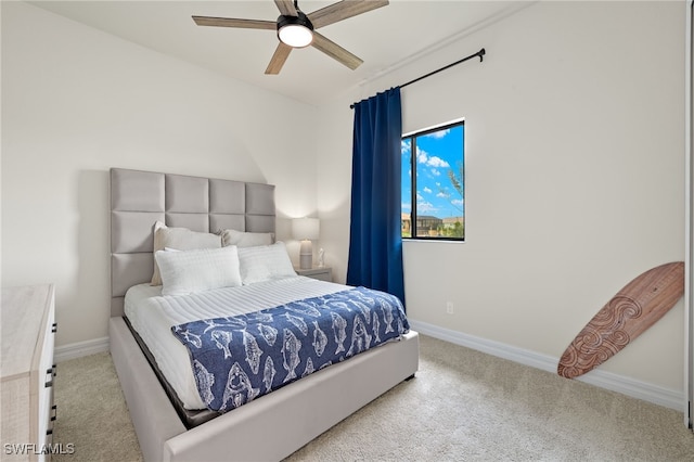 bedroom with ceiling fan and light carpet