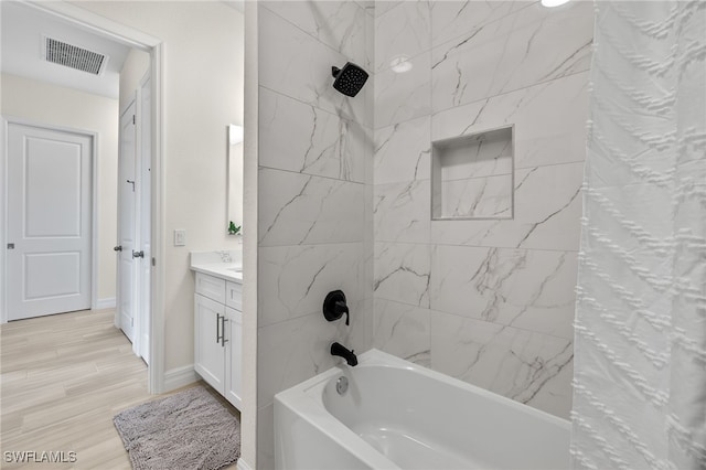 bathroom featuring shower / bath combination with curtain, vanity, and hardwood / wood-style flooring