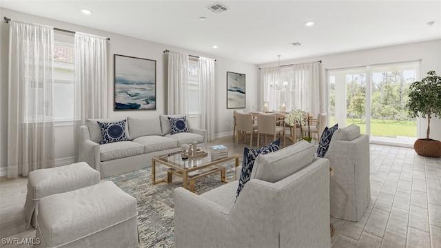 living area featuring baseboards, an inviting chandelier, visible vents, and recessed lighting