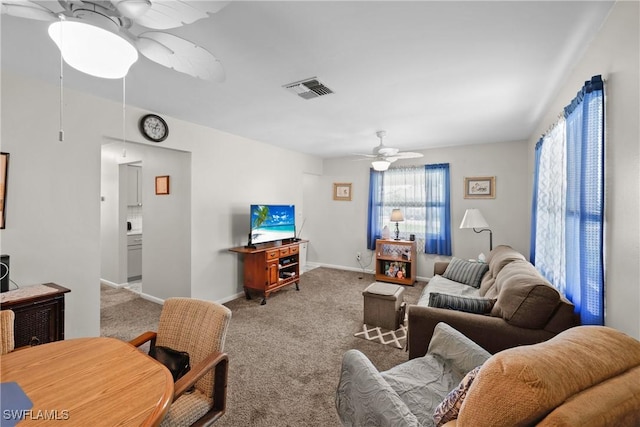 living room with light carpet and ceiling fan