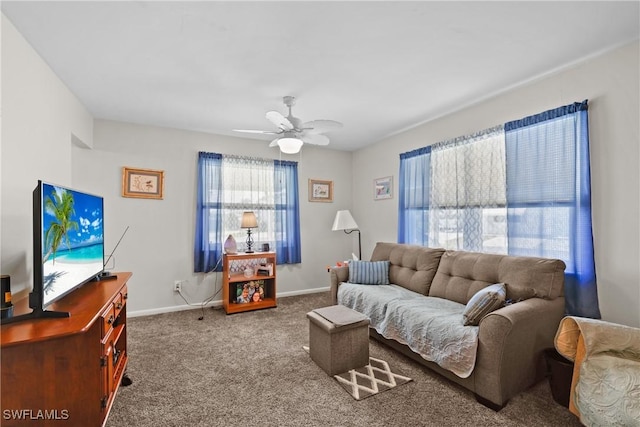 carpeted living room with ceiling fan