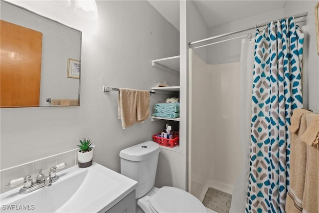 bathroom featuring toilet, vanity, and a shower with curtain