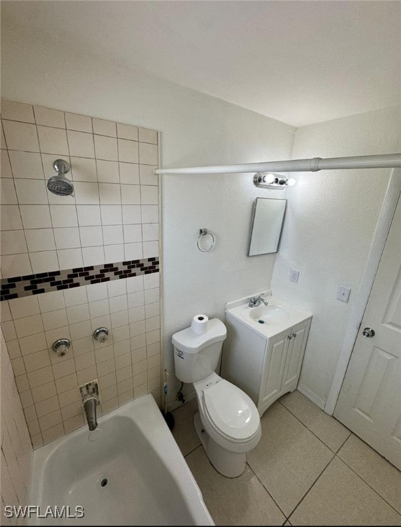 full bathroom featuring tile patterned flooring, vanity, tiled shower / bath combo, and toilet