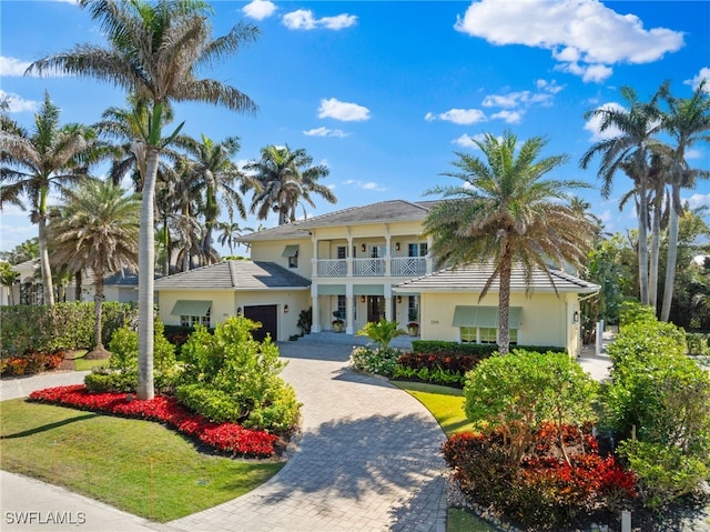 view of front of property with a front lawn and a balcony