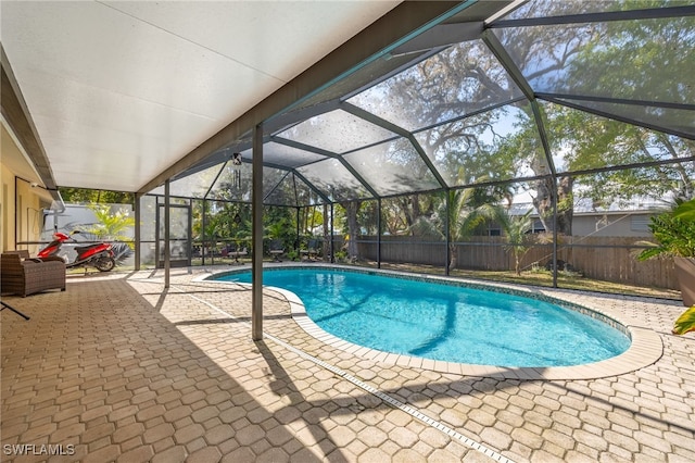 view of swimming pool with a lanai and a patio area