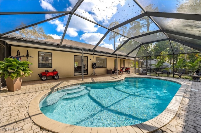 view of pool featuring a lanai and a patio