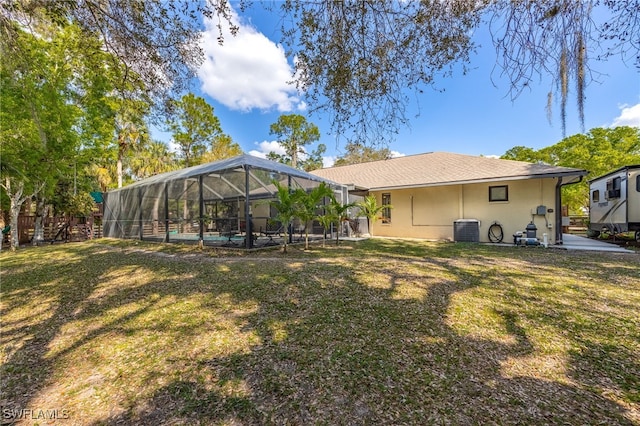 back of house with cooling unit, a pool, a yard, and a lanai