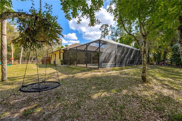 view of yard featuring glass enclosure