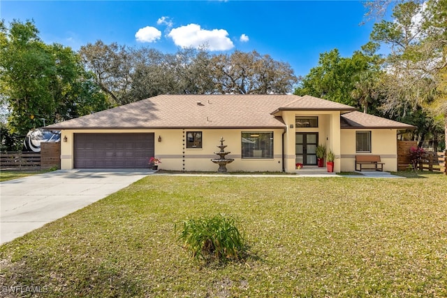 view of front of home featuring a garage and a front lawn