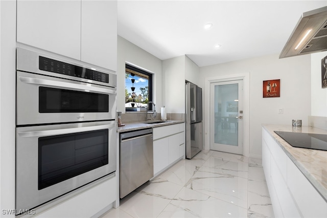 kitchen with sink, extractor fan, light stone counters, stainless steel appliances, and white cabinets