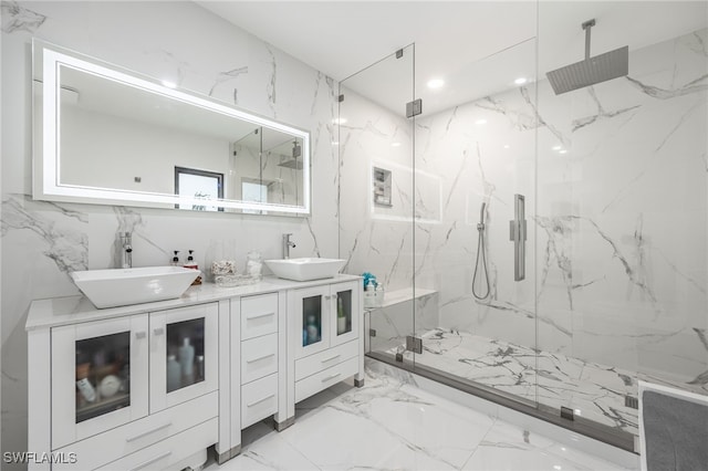 bathroom with vanity, tile walls, and a shower with shower door