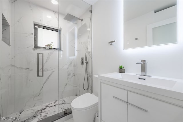 bathroom with vanity, toilet, and a shower with door