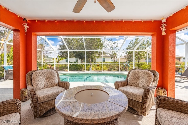 sunroom with a swimming pool and ceiling fan