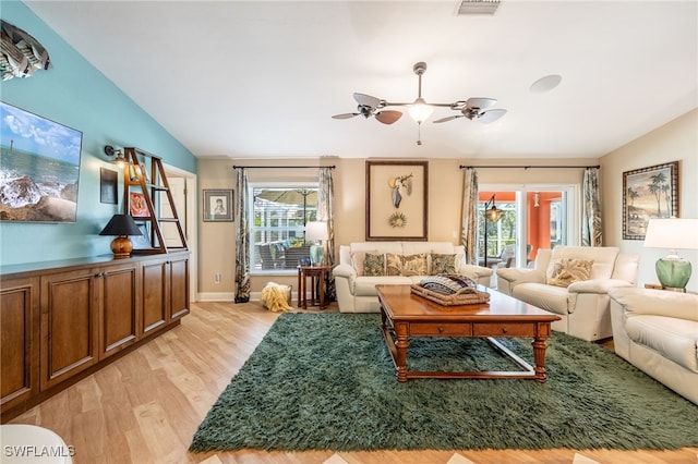 living room with vaulted ceiling, light hardwood / wood-style floors, ceiling fan, and plenty of natural light