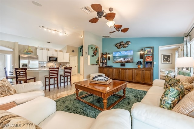 living room featuring lofted ceiling and ceiling fan