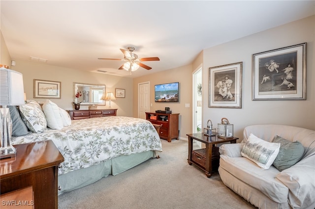 bedroom with ceiling fan, a closet, and light carpet