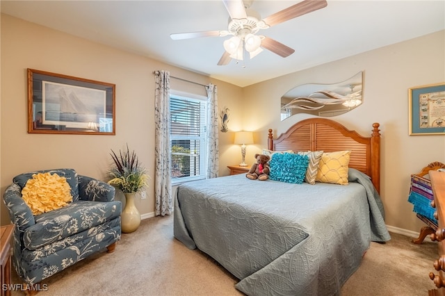 bedroom with ceiling fan and light carpet