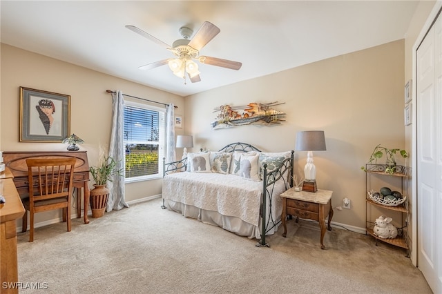 bedroom with light colored carpet, a closet, and ceiling fan