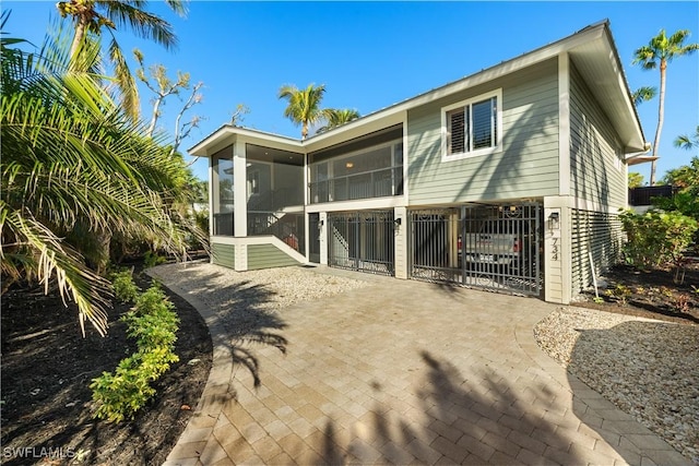 rear view of property featuring a sunroom