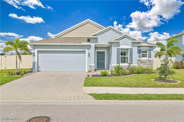 view of front of house featuring a garage and a front yard