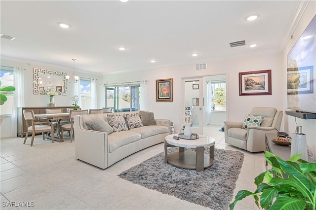 living room with crown molding, plenty of natural light, and light tile patterned floors