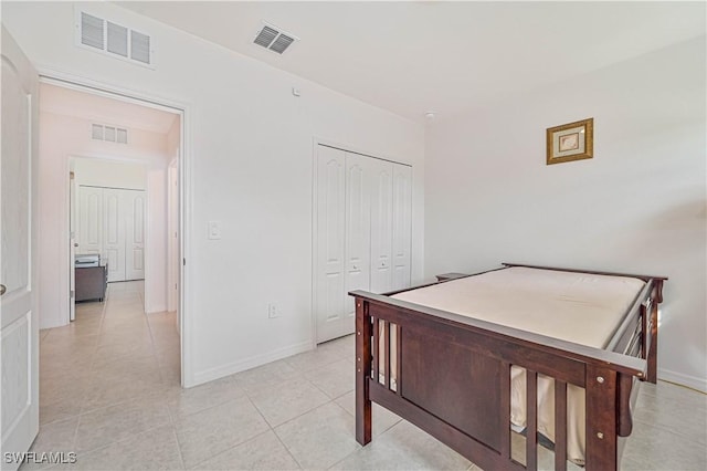 bedroom featuring a closet and light tile patterned flooring