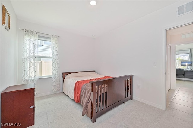 bedroom with light tile patterned floors