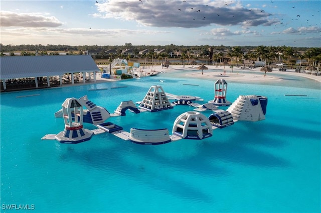 view of swimming pool with a water view